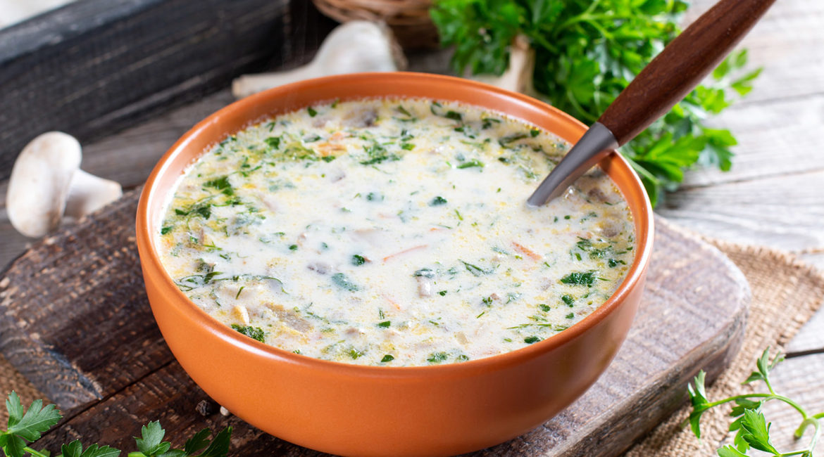 Cheese soup with mushrooms, potatoes and carrots. Delicious cozy first course, tasty autumn food