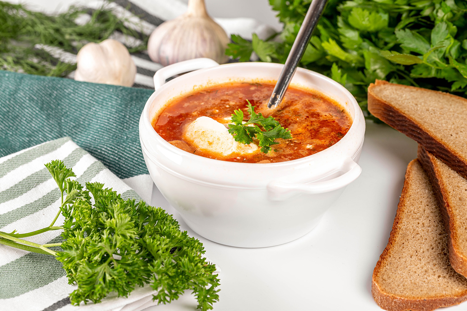 Vegetable tomato soup with sour cream and herbs